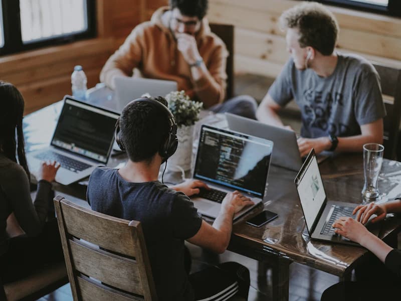 A small team collaborating at a bright, modern workspace